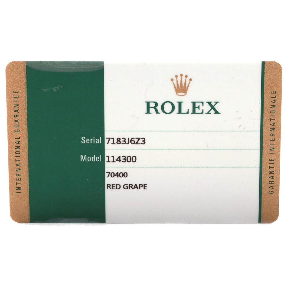 This image shows the international guarantee card for a Rolex Oyster Perpetual 114300 Men's Stainless Steel Burgundy Dial 114300 Men's Stainless Steel Burgundy Dial model 114300 with serial number 7183J6Z3.