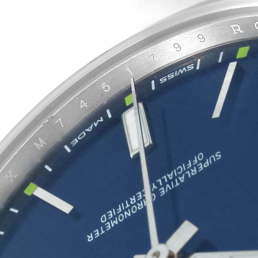 This image shows a close-up of the dial and hand of a Rolex Oyster Perpetual 114300 Men
s Stainless Steel Blue Dial 114300 Men
s Stainless Steel Blue Dial watch, highlighting the markings and text.