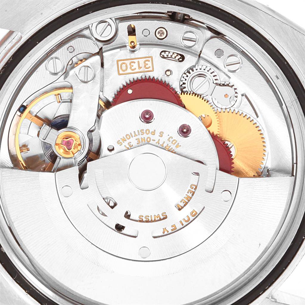 The image shows a close-up of the inner movement mechanism of a Rolex Oyster Perpetual 116000 Men
s Stainless Steel Blue Dial 116000 Men
s Stainless Steel Blue Dial watch.