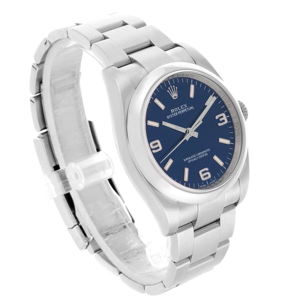 This Rolex Oyster Perpetual 116000 Men
s Stainless Steel Blue Dial 116000 Men
s Stainless Steel Blue Dial watch is shown in a side angle, displaying its dial, case, and bracelet.