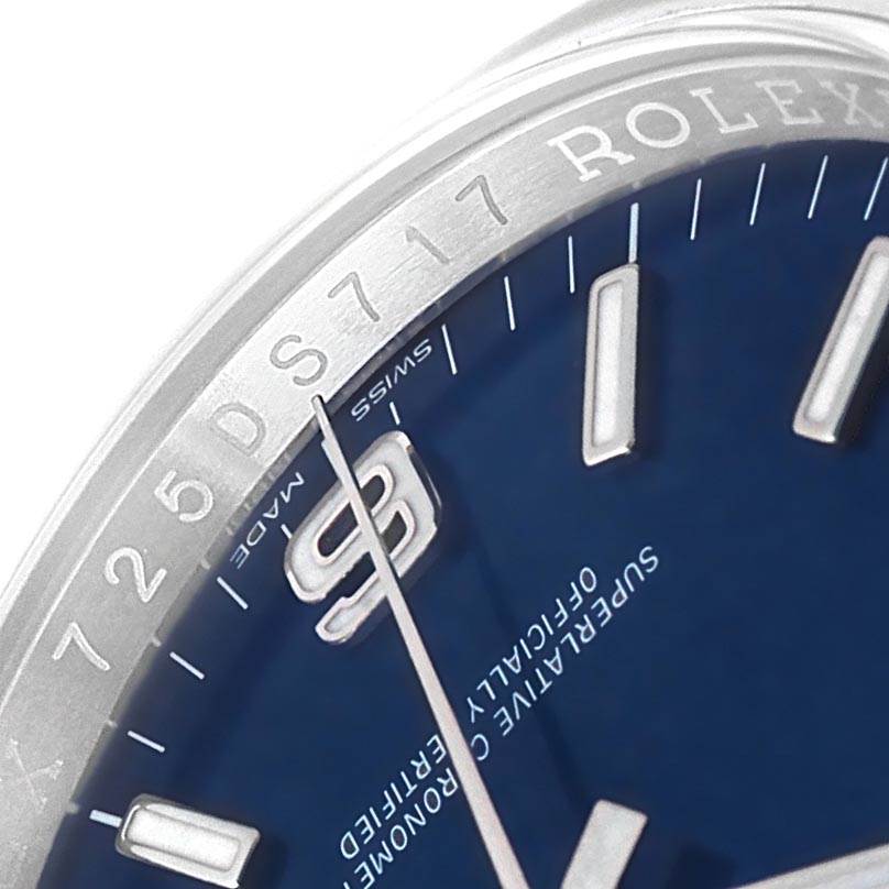 This close-up angle of the Rolex Oyster Perpetual 116000 Men
s Stainless Steel Blue Dial 116000 Men
s Stainless Steel Blue Dial watch shows part of the dial, bezel, and hands.