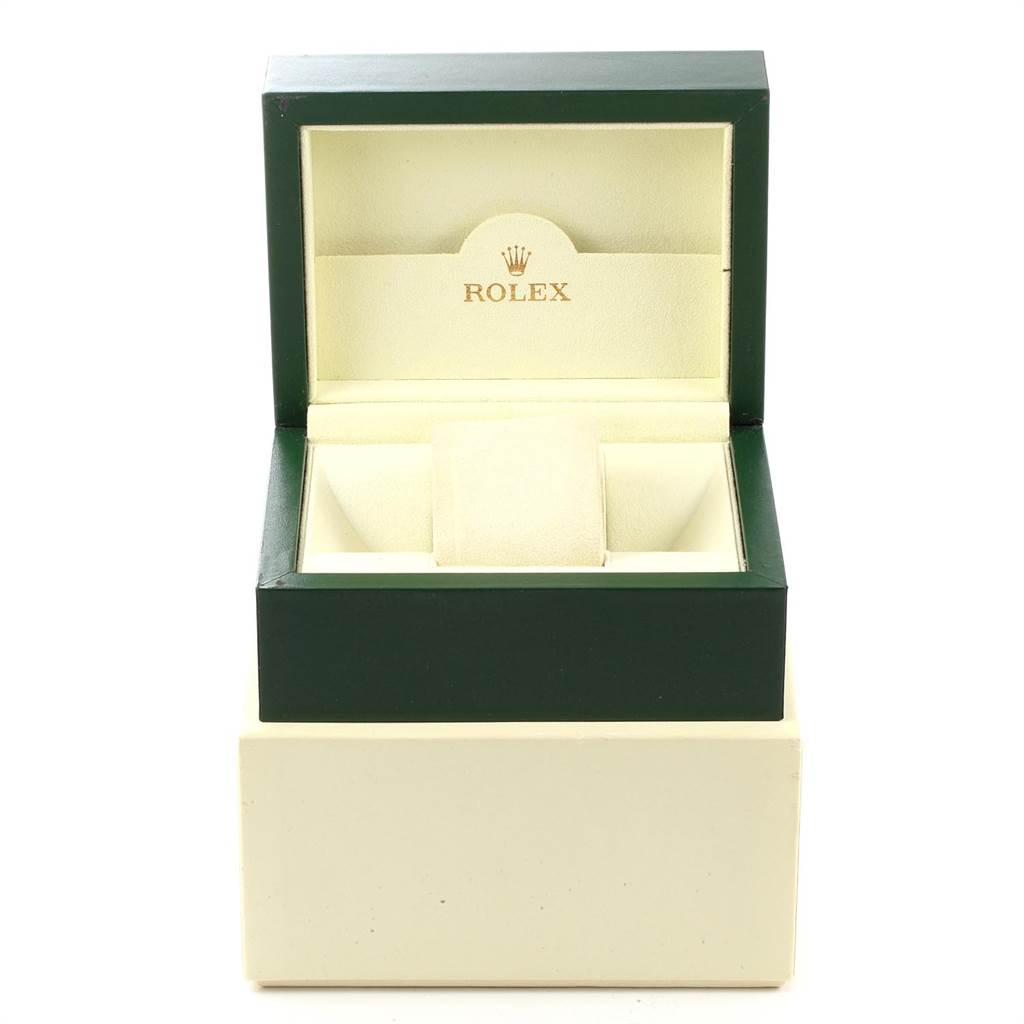 The image displays an open Rolex Oyster Perpetual 116000 Men
s Stainless Steel Silver Dial 116000 Men
s Stainless Steel Silver Dial watch box with a green exterior and beige interior.