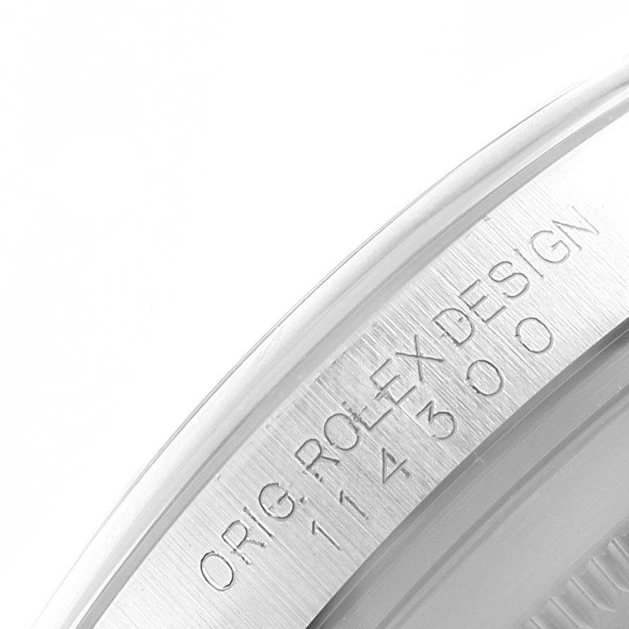 This image shows a close-up of the side of a Rolex Oyster Perpetual 114300 Men
s Stainless Steel Black Dial 114300 Men
s Stainless Steel Black Dial watch, displaying the engraved model number and design details.