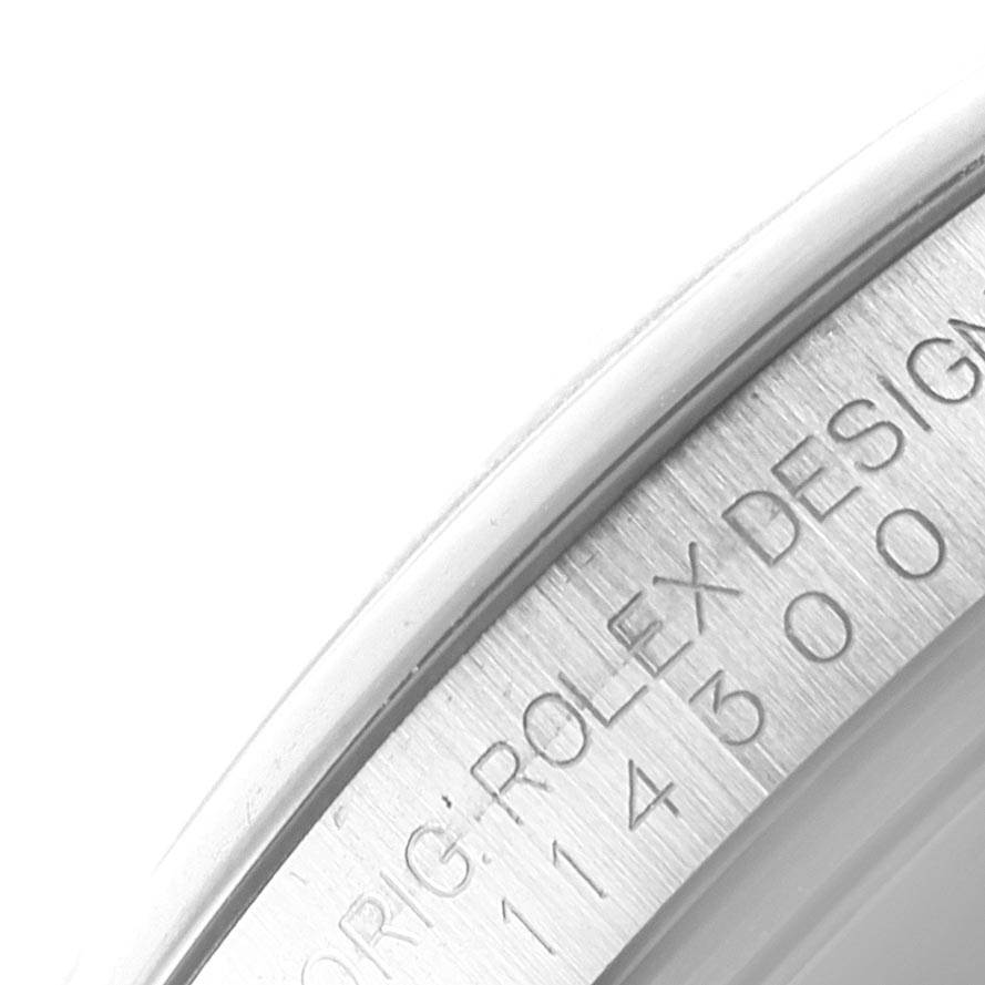 This image shows a close-up of the engraved inner bezel of a Rolex Oyster Perpetual 114300 Men
s Stainless Steel Grey Dial 114300 Men
s Stainless Steel Grey Dial watch.