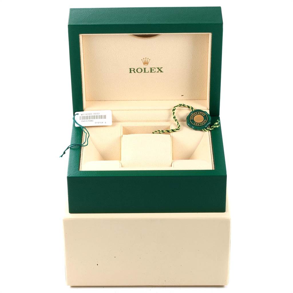 The image shows the open packaging box for the Rolex Oyster Perpetual 114200 Men's Stainless Steel Champagne Dial 114200 Men's Stainless Steel Champagne Dial watch, displaying the interior and watch tags.