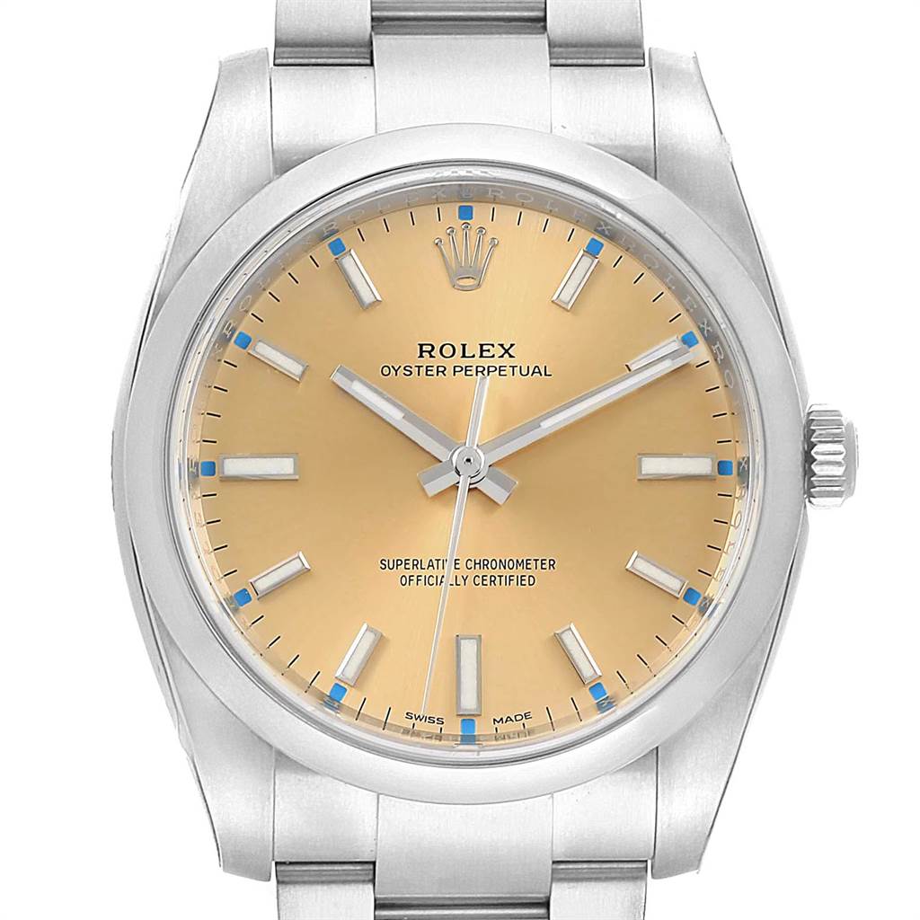 The image shows a frontal view of a Rolex Oyster Perpetual 114200 Men's Stainless Steel Champagne Dial 114200 Men's Stainless Steel Champagne Dial watch, displaying the face, bezel, and part of the bracelet.