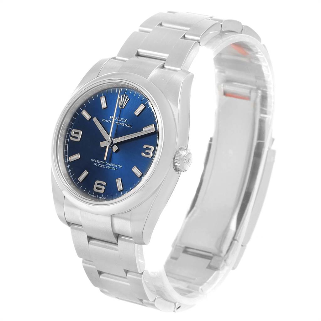 The image shows a side and slightly angled front view of a Rolex Oyster Perpetual 114200 Men
s Stainless Steel Blue Dial 114200 Men
s Stainless Steel Blue Dial with a blue dial and silver bracelet.