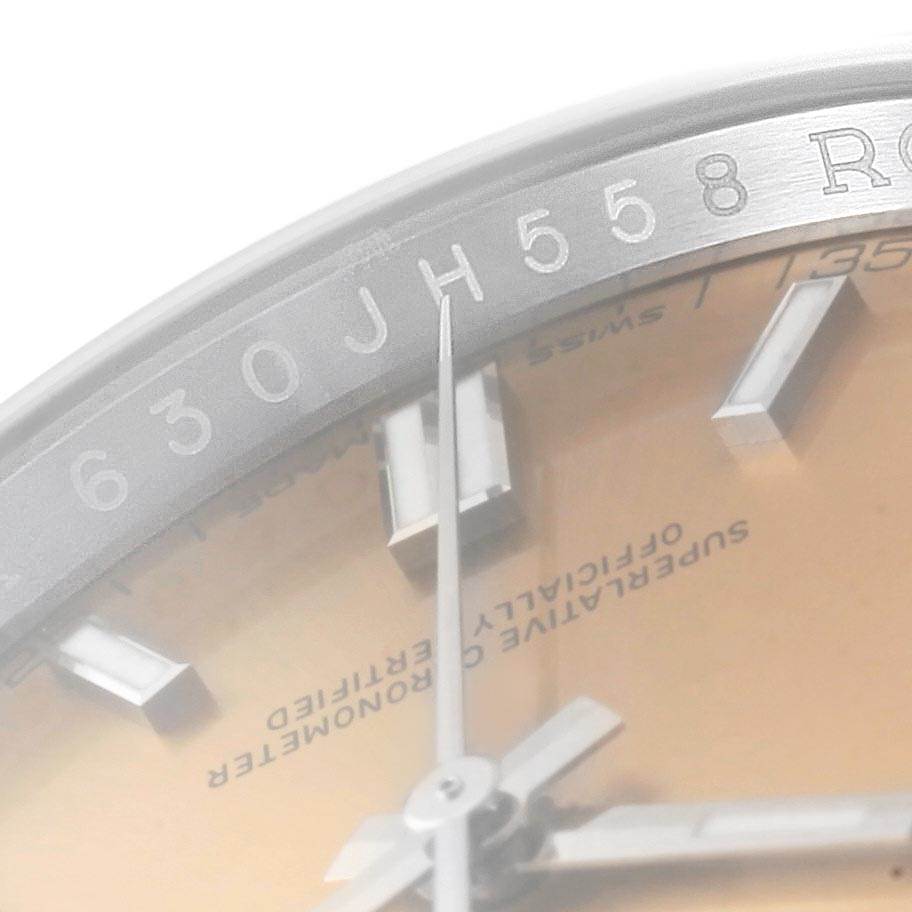 The image shows a close-up of the dial and the inner bezel with serial numbers on the Rolex Oyster Perpetual 116000 Men
s Stainless Steel Champagne Dial 116000 Men
s Stainless Steel Champagne Dial watch.