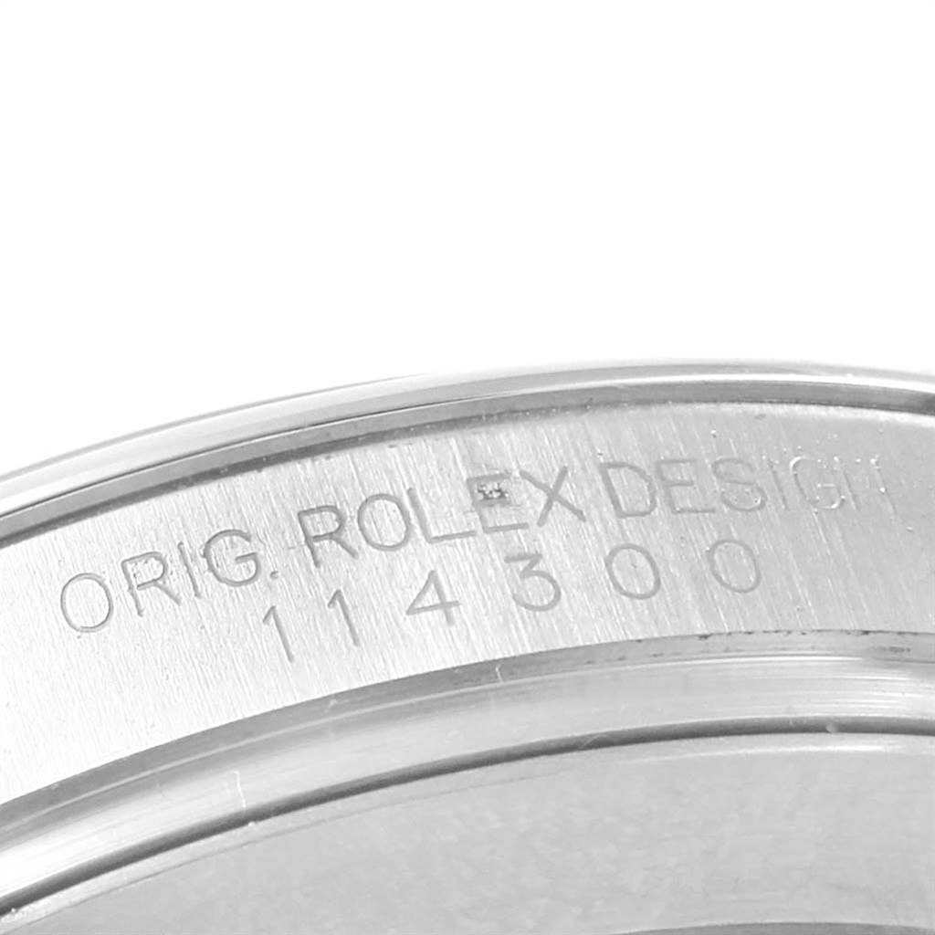 This image shows the side engraving of the case on a Rolex Oyster Perpetual 114300 Men
s Stainless Steel Grey Dial 114300 Men
s Stainless Steel Grey Dial watch, displaying the model number 114300.