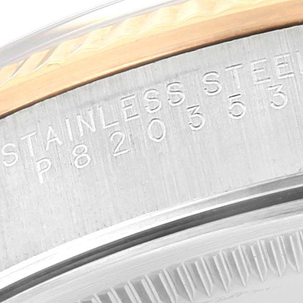 This close-up image shows the engraved stainless steel casing of a Rolex Oyster Perpetual 14233 Men
s Steel and Gold (two tone) Blue Dial 14233 Men
s Steel and Gold (two tone) Blue Dial watch.