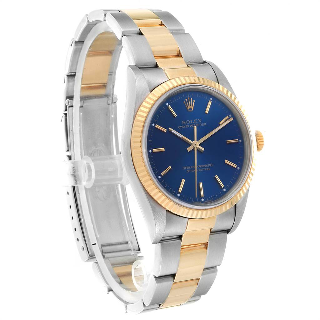This image shows a side angle view of a Rolex Oyster Perpetual 14233 Men
s Steel and Gold (two tone) Blue Dial 14233 Men
s Steel and Gold (two tone) Blue Dial watch, highlighting the bracelet, blue dial, and gold bezel.