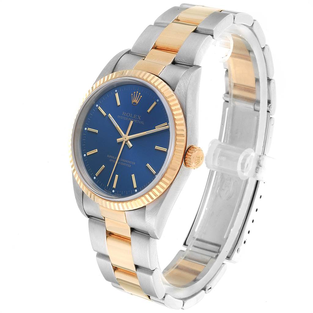 The Rolex Oyster Perpetual 14233 Men
s Steel and Gold (two tone) Blue Dial 14233 Men
s Steel and Gold (two tone) Blue Dial watch is shown at a slight angle, revealing the face, bezel, and a portion of the bracelet.