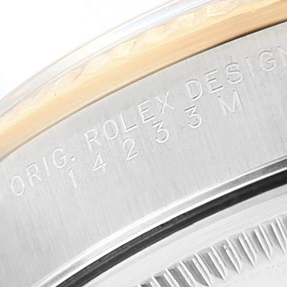 This image shows a close-up angle of the bezel and case edge of a Rolex Oyster Perpetual 14233 Men
s Steel and Gold (two tone) Blue Dial 14233 Men
s Steel and Gold (two tone) Blue Dial watch, displaying the engraved text.