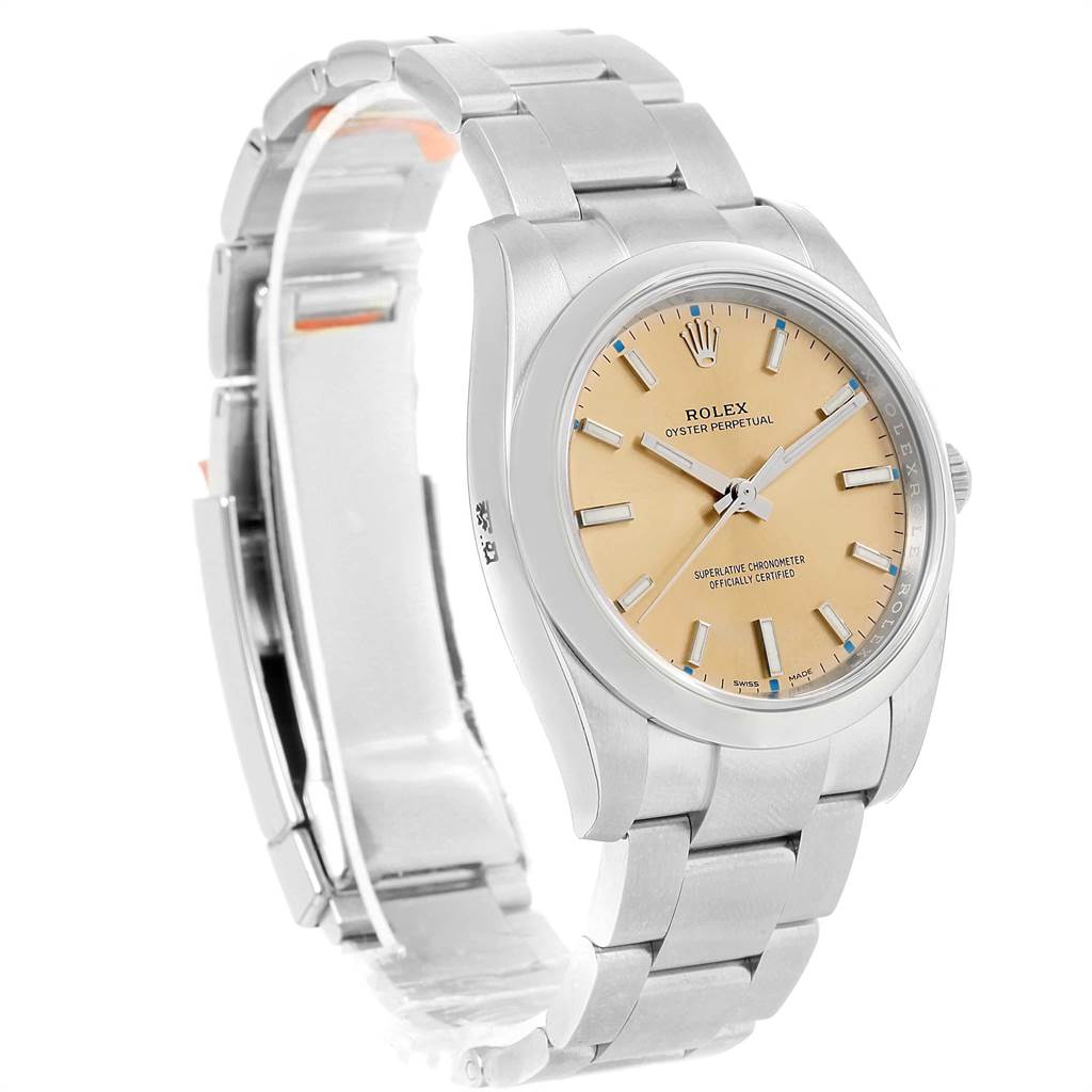 This Rolex Oyster Perpetual 114200 Men
s Stainless Steel Champagne Dial 114200 Men
s Stainless Steel Champagne Dial watch is shown from a three-quarter angle, highlighting the face, bezel, and partially open bracelet.