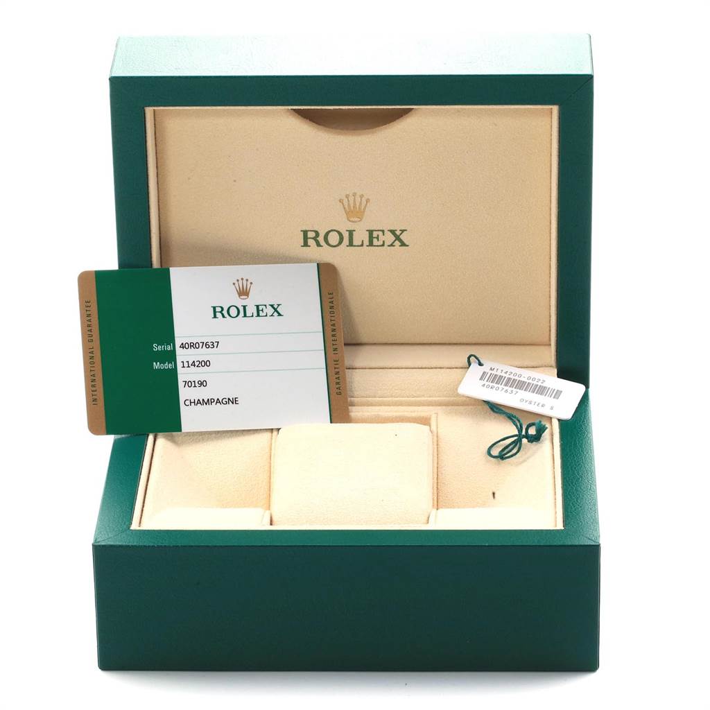 The image shows the interior of a green Rolex box with an Best Quality
ity card and tags for an Oyster Perpetual model watch.