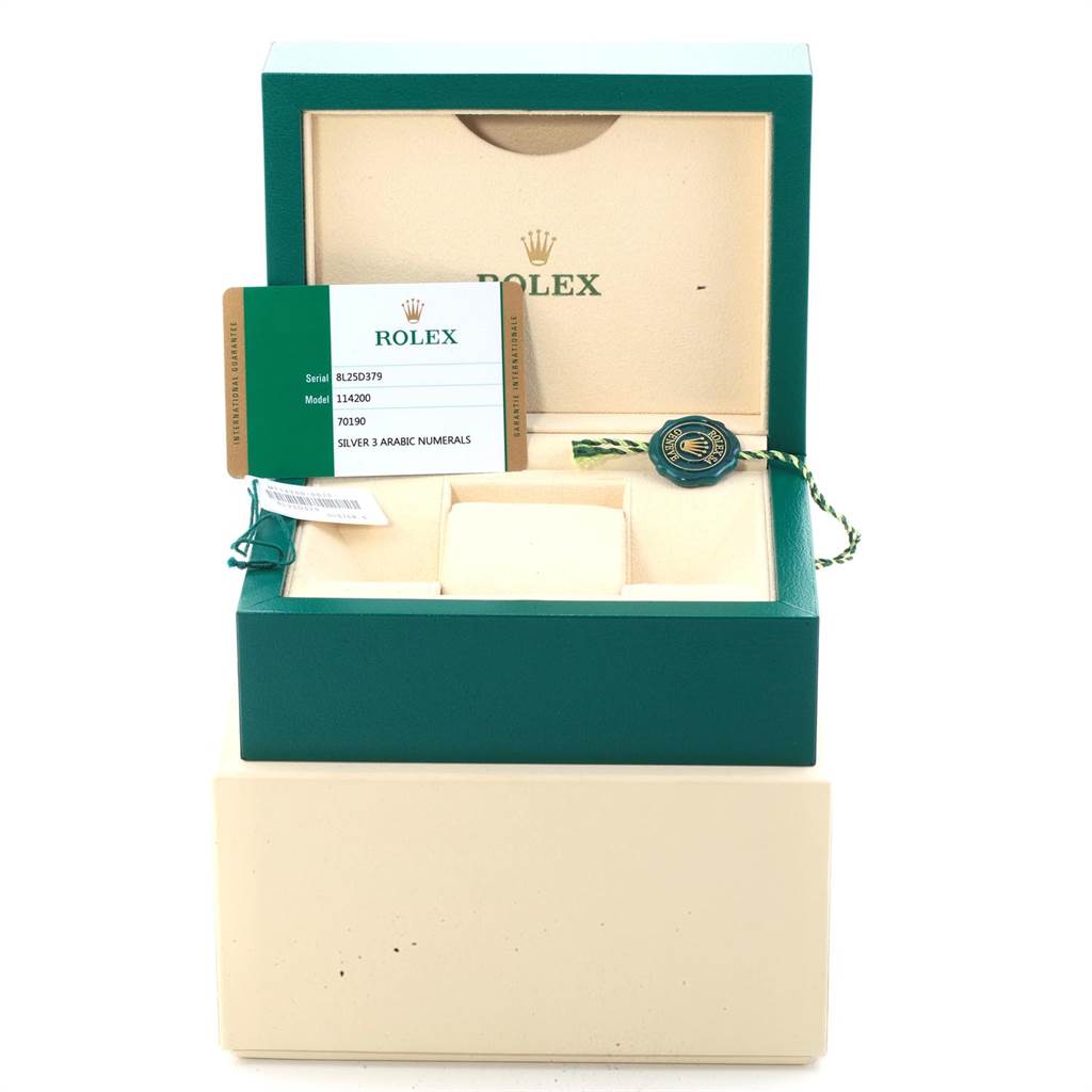 This image shows a Rolex Oyster Perpetual 114200 Men
s Stainless Steel Silver Dial 114200 Men
s Stainless Steel Silver Dial watch box, warranty card, and hang tag from a straight-on angle.