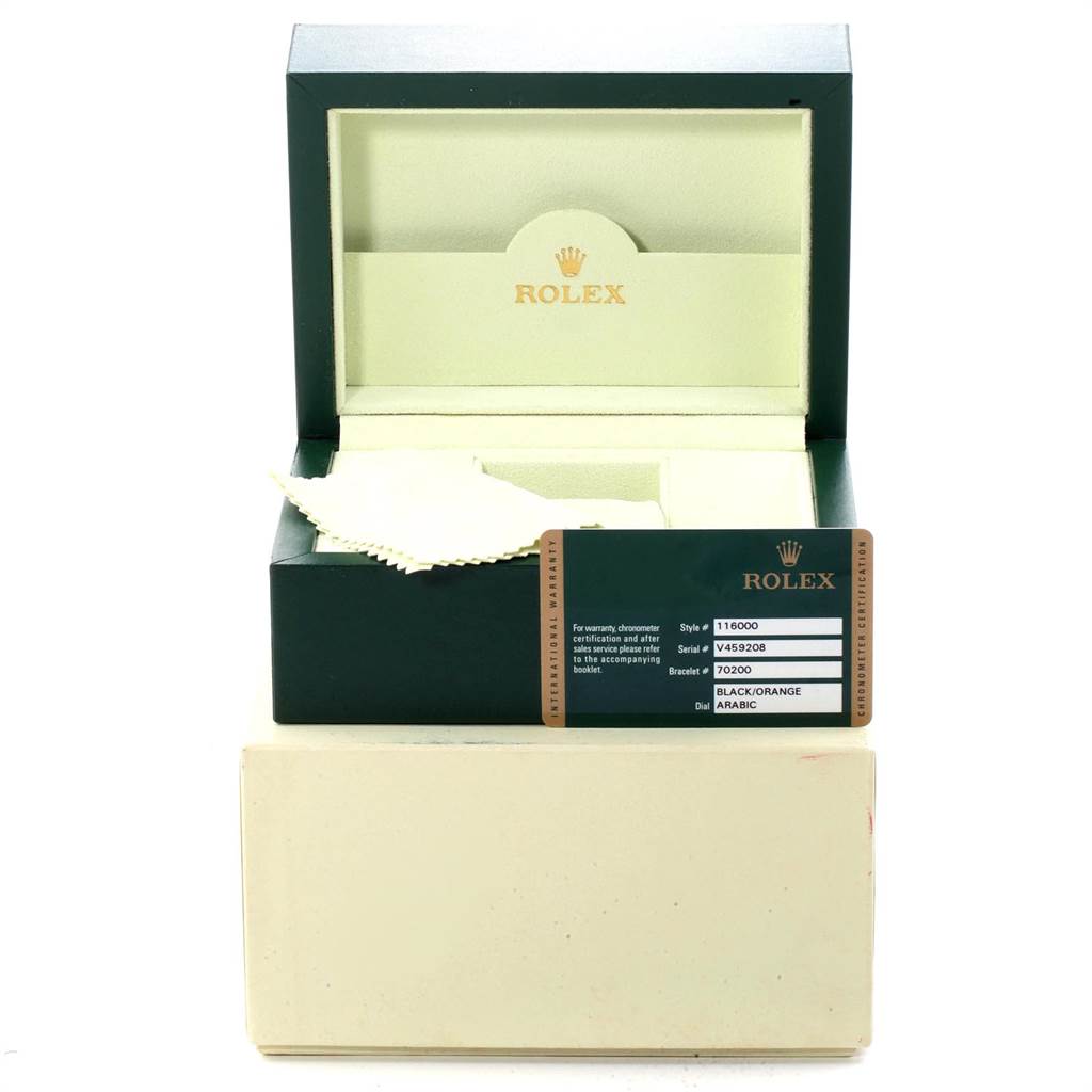 This image shows the opened box and warranty card of a Rolex Oyster Perpetual 116000 Men
s Stainless Steel Black Dial 116000 Men
s Stainless Steel Black Dial watch, with the inside of the box visible.