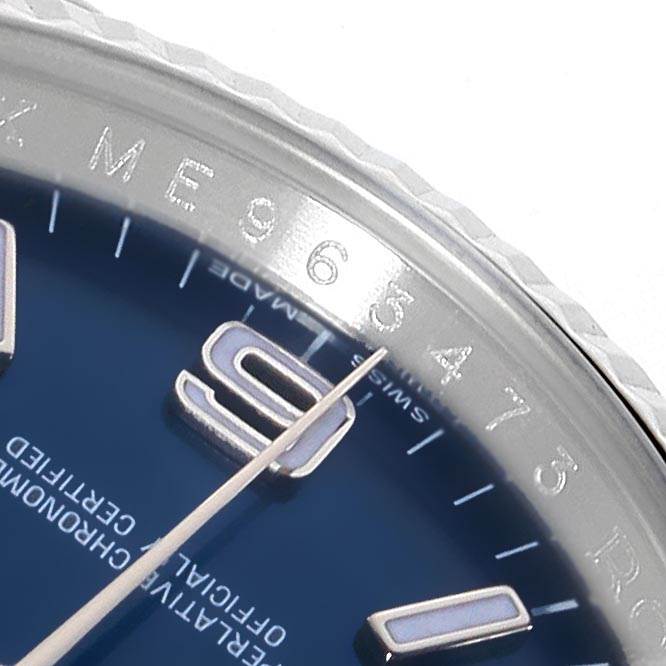 This is a close-up of the Rolex Oyster Perpetual 116034 Men's Stainless Steel Blue Dial 116034 Men's Stainless Steel Blue Dial watch showing part of the bezel, the edge of the dial, and the 9 marker.