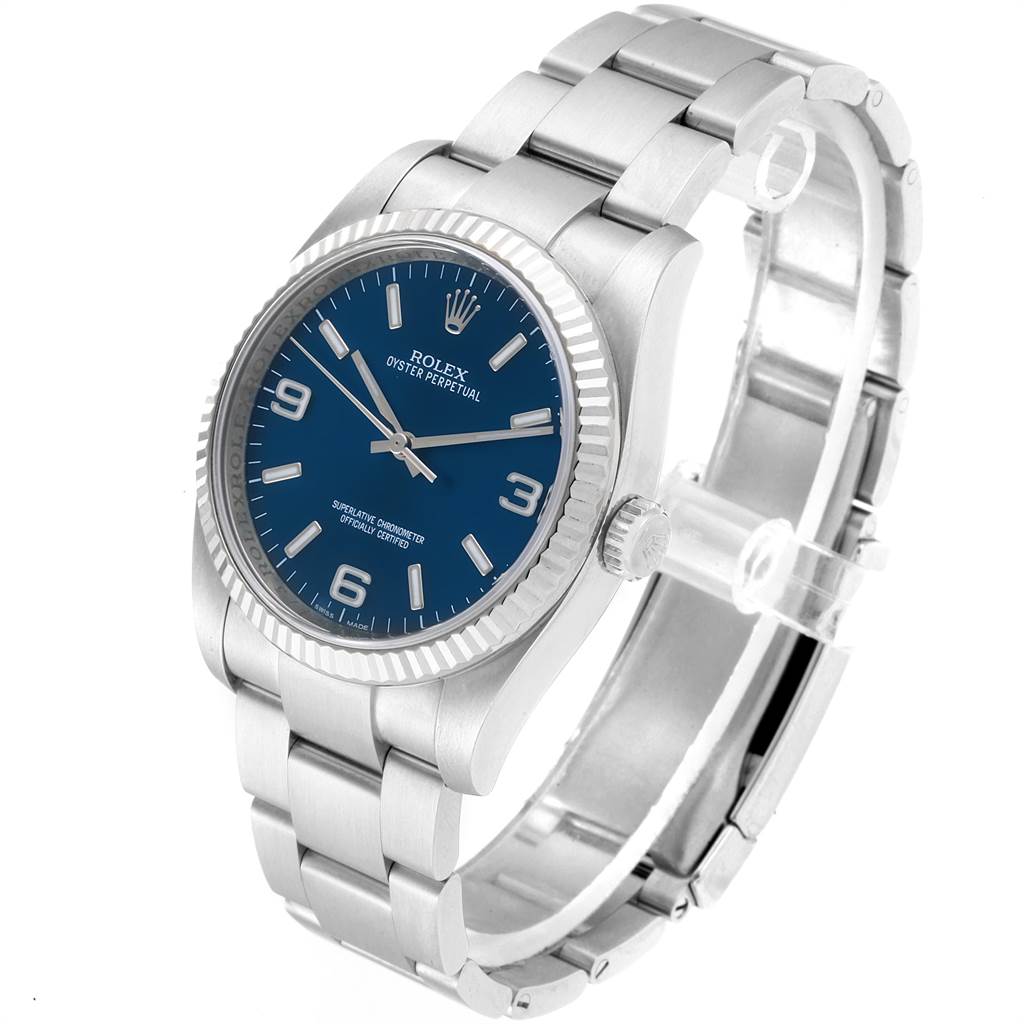 The Rolex Oyster Perpetual 116034 Men's Stainless Steel Blue Dial 116034 Men's Stainless Steel Blue Dial watch is shown at a slight angle, highlighting the blue dial, stainless steel case, fluted bezel, and bracelet.