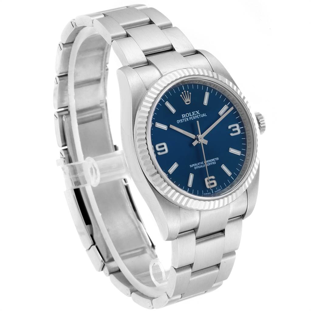 The image shows a side-angle view of a Rolex Oyster Perpetual 116034 Men's Stainless Steel Blue Dial 116034 Men's Stainless Steel Blue Dial watch, highlighting its blue dial and stainless steel bracelet.