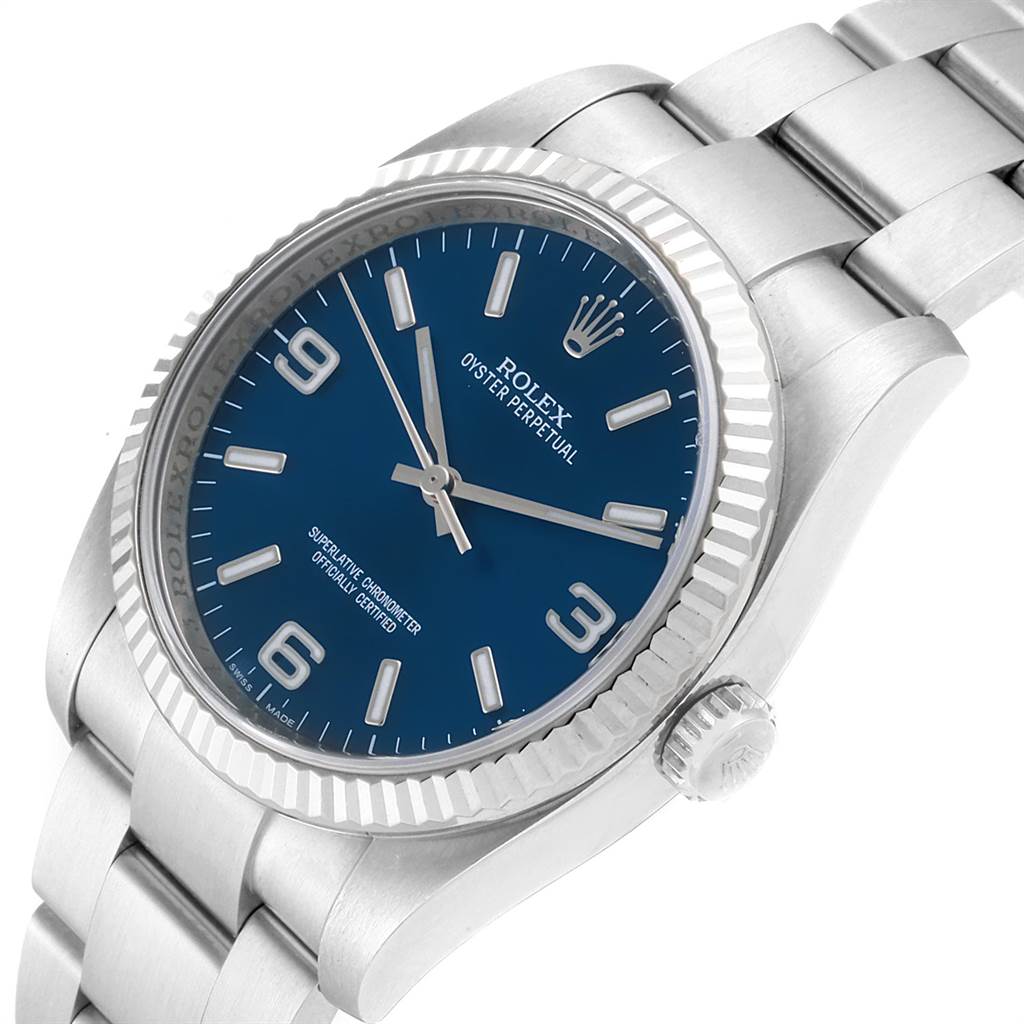 The image shows a Rolex Oyster Perpetual 116034 Men's Stainless Steel Blue Dial 116034 Men's Stainless Steel Blue Dial watch at an angled view, highlighting the blue dial, bezel, and part of the bracelet.
