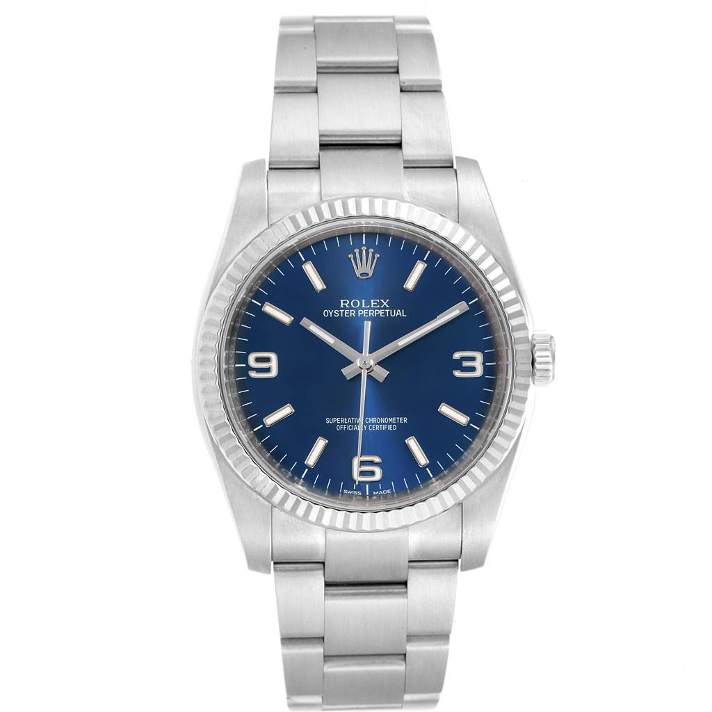 The image shows a Rolex Oyster Perpetual 116034 Men's Stainless Steel Blue Dial 116034 Men's Stainless Steel Blue Dial watch from a front angle, highlighting its blue dial, bezel, and metal bracelet.
