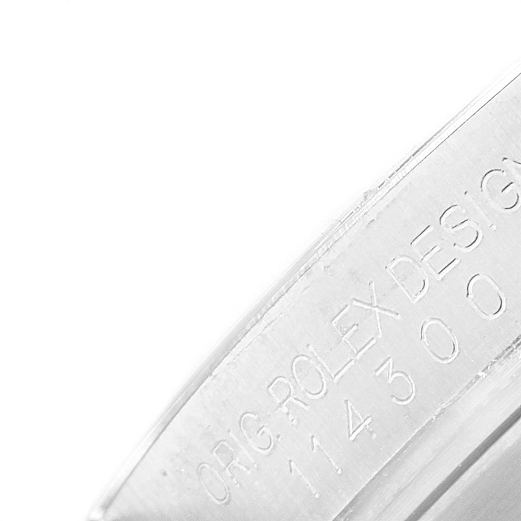 This image shows a close-up view of the engravings on the inner rim of the case of a Rolex Oyster Perpetual 114300 Men
s Stainless Steel Silver Dial 114300 Men
s Stainless Steel Silver Dial watch.