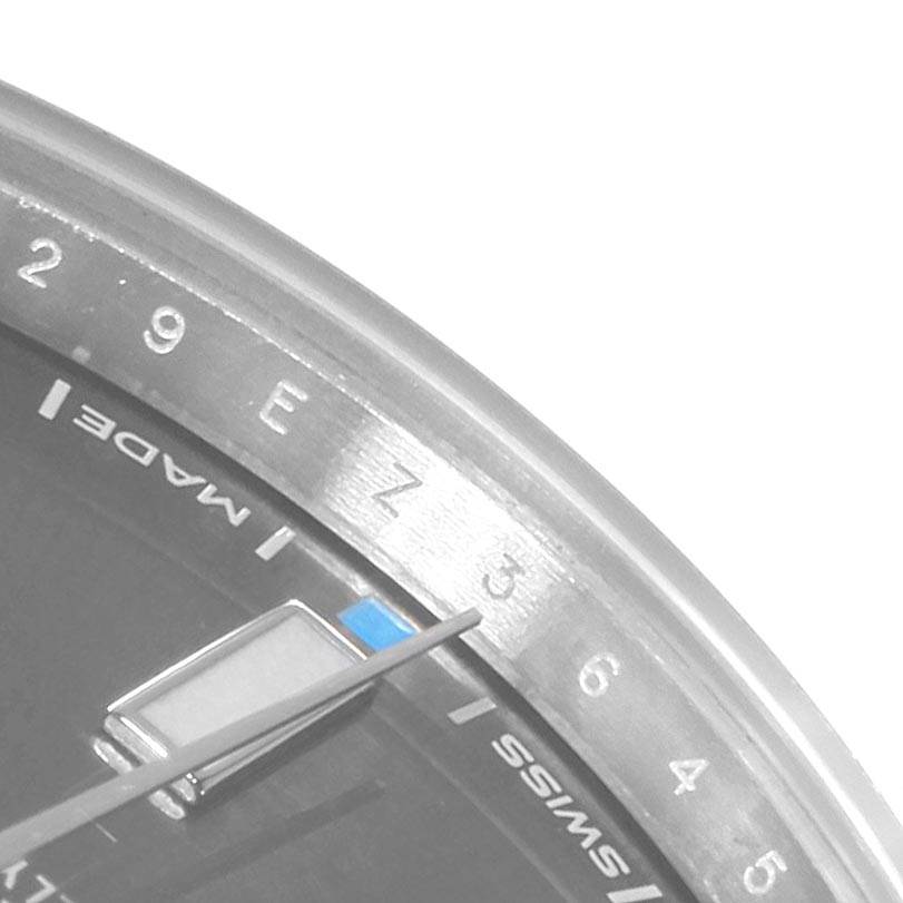 This close-up angle of the Rolex Oyster Perpetual 114300 Men
s Stainless Steel Silver Dial 114300 Men
s Stainless Steel Silver Dial watch shows the dial edge, part of the second hand, and some hour markers.