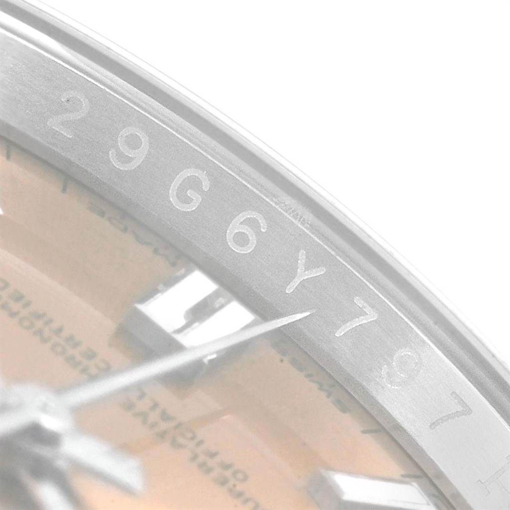 This close-up image shows the serial number engraving on the bezel of a Rolex Oyster Perpetual 116000 Men's Stainless Steel Champagne Dial 116000 Men's Stainless Steel Champagne Dial watch.