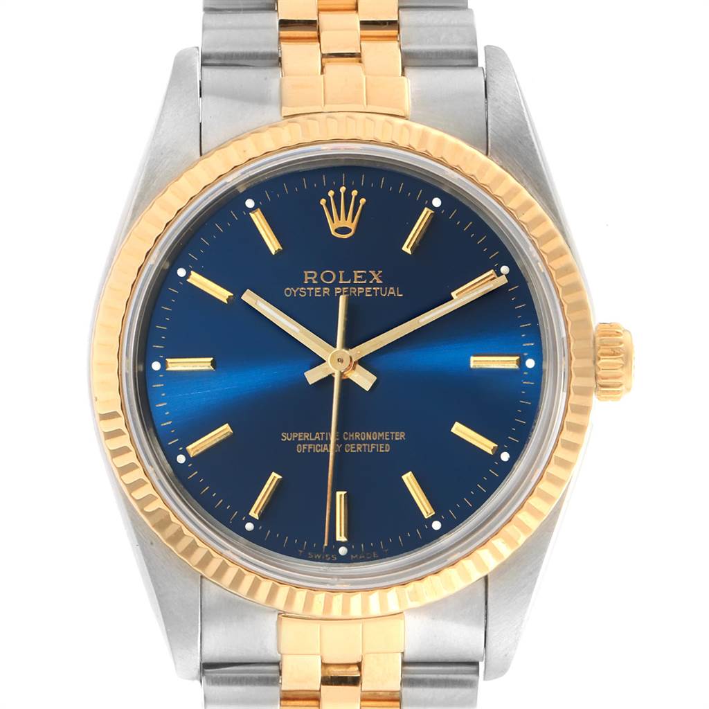 This Rolex Oyster Perpetual 14233 Men's Steel and Gold (two tone) Blue Dial 14233 Men's Steel and Gold (two tone) Blue Dial watch is shown from a front angle, displaying its blue dial, gold bezel, and two-tone bracelet.