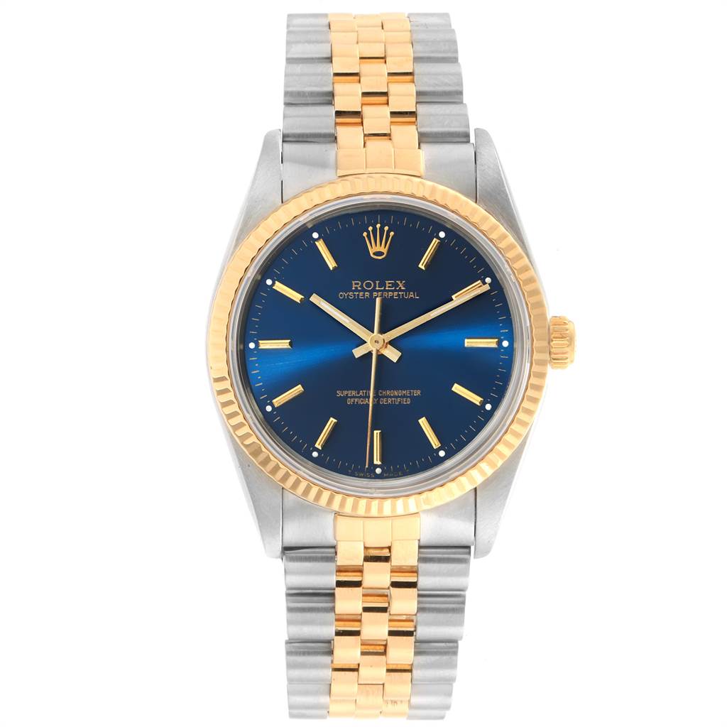 The image shows a front angle of a Rolex Oyster Perpetual 14233 Men's Steel and Gold (two tone) Blue Dial 14233 Men's Steel and Gold (two tone) Blue Dial watch featuring a blue dial, gold bezel, and two-tone metal bracelet.