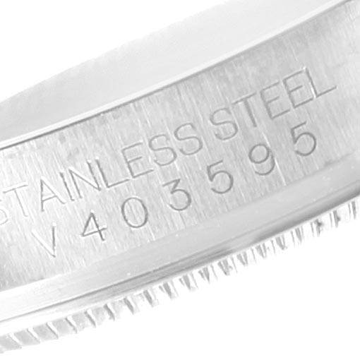 This image shows the serial number and "STAINLESS STEEL" engraving on the edge of the Oyster Perpetual model by Rolex.