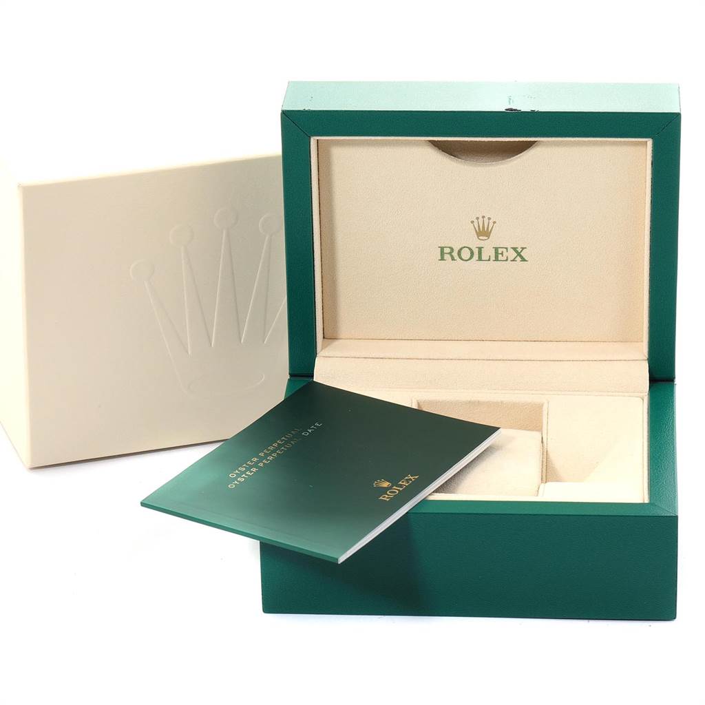 This image shows an open Rolex Oyster Perpetual 114300 Men's Stainless Steel Blue Dial 114300 Men's Stainless Steel Blue Dial watch box and a warranty booklet.