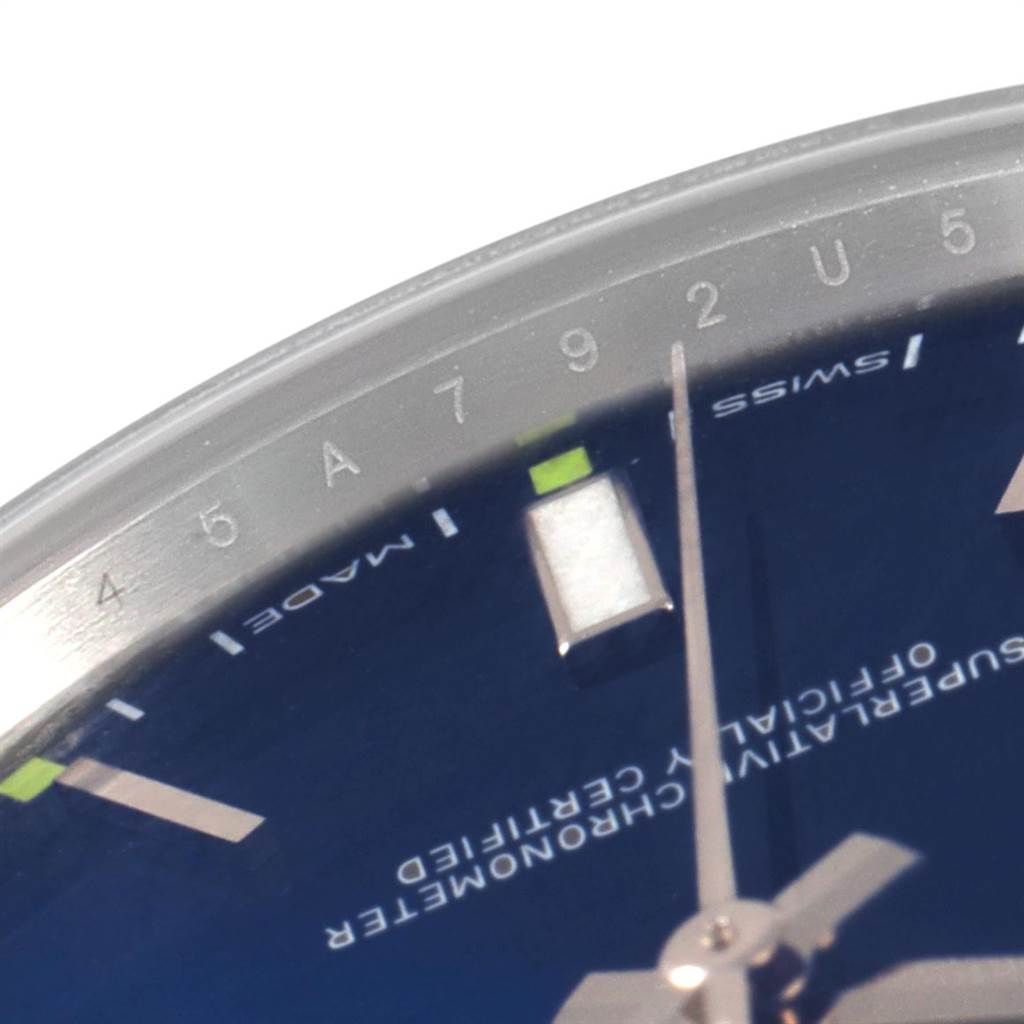 This image shows a close-up of the dial of a Rolex Oyster Perpetual 114300 Men's Stainless Steel Blue Dial 114300 Men's Stainless Steel Blue Dial watch, focusing on the hour markers and hands.