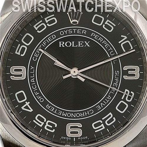 This image shows a close-up of the dial of a Rolex Oyster Perpetual 116000 Men's Stainless Steel Black Dial 116000 Men's Stainless Steel Black Dial watch, highlighting the numerals and hands.