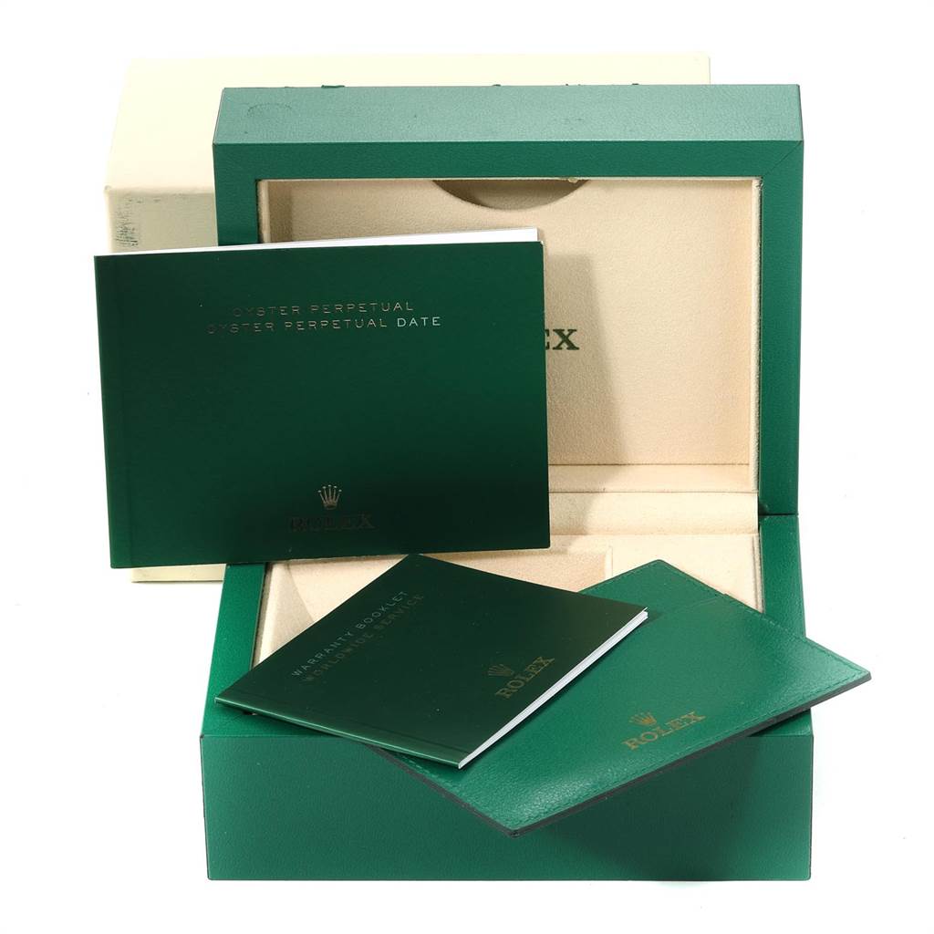 This image shows the box and accompanying documents of a Rolex Oyster Perpetual 116000 Men's Stainless Steel Burgundy Dial 116000 Men's Stainless Steel Burgundy Dial watch viewed from the front.