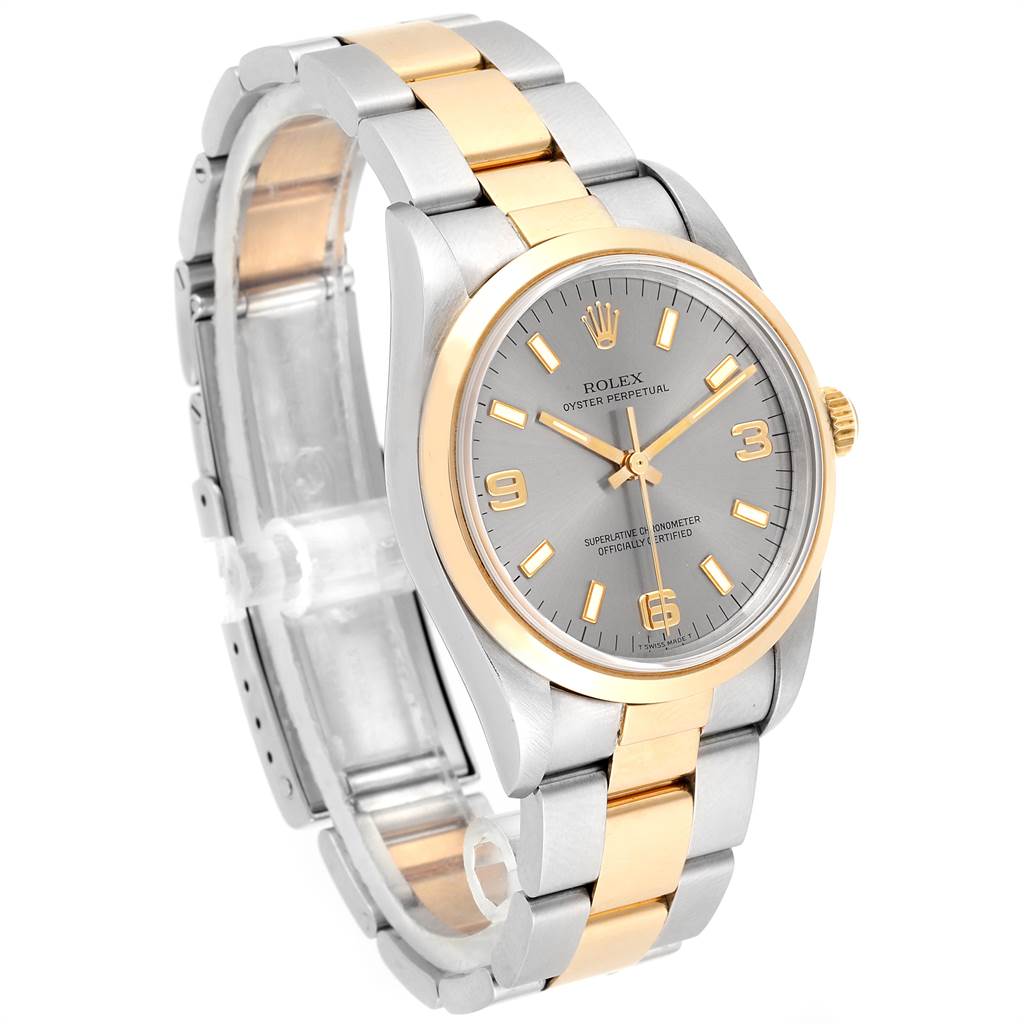 The Rolex Oyster Perpetual 14203 Men's Steel and Gold (two tone) Grey Dial 14203 Men's Steel and Gold (two tone) Grey Dial watch is shown from a three-quarter angle, displaying the dial, bezel, and bracelet.
