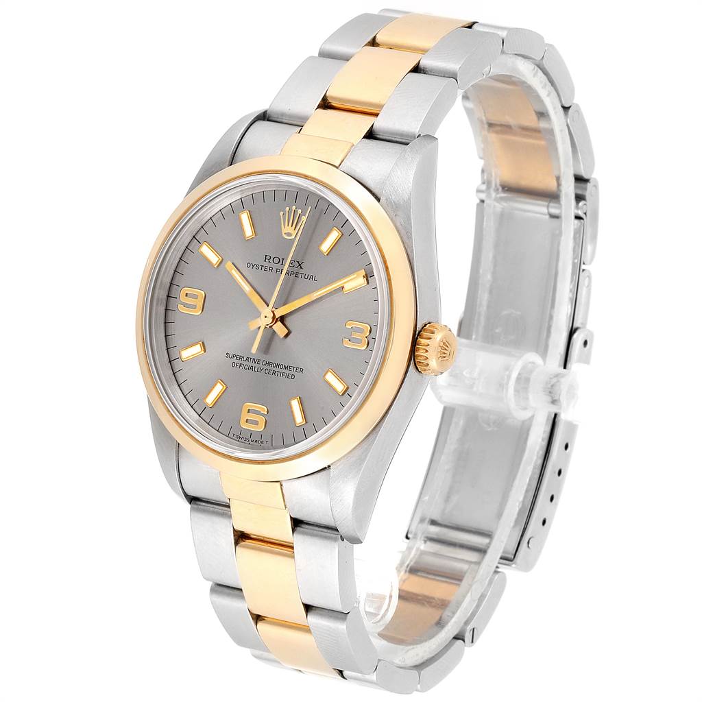 The Rolex Oyster Perpetual 14203 Men's Steel and Gold (two tone) Grey Dial 14203 Men's Steel and Gold (two tone) Grey Dial watch is shown at an angle displaying its face, bracelet, and crown, with a two-tone metal finish.