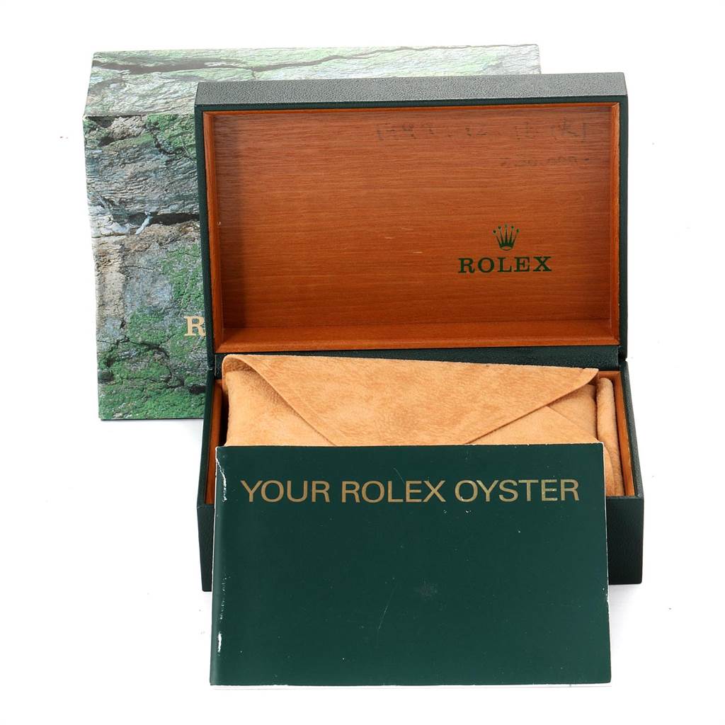 This image shows an open Rolex Oyster Perpetual 14203 Men's Steel and Gold (two tone) Grey Dial 14203 Men's Steel and Gold (two tone) Grey Dial watch box, with a booklet and cushion inside, photographed from the front.