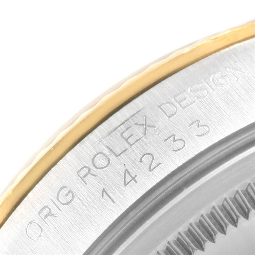 This image shows a close-up of the bezel and part of the case back of a Rolex Oyster Perpetual 14233 Men's Steel and Gold (two tone) Black Dial 14233 Men's Steel and Gold (two tone) Black Dial watch.