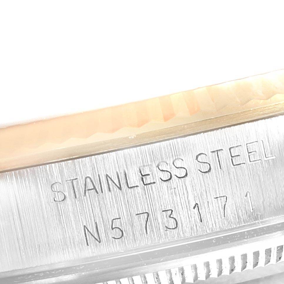 This close-up image shows the side engraving on the stainless steel casing of a Rolex Oyster Perpetual 14233 Men's Steel and Gold (two tone) Black Dial 14233 Men's Steel and Gold (two tone) Black Dial watch.