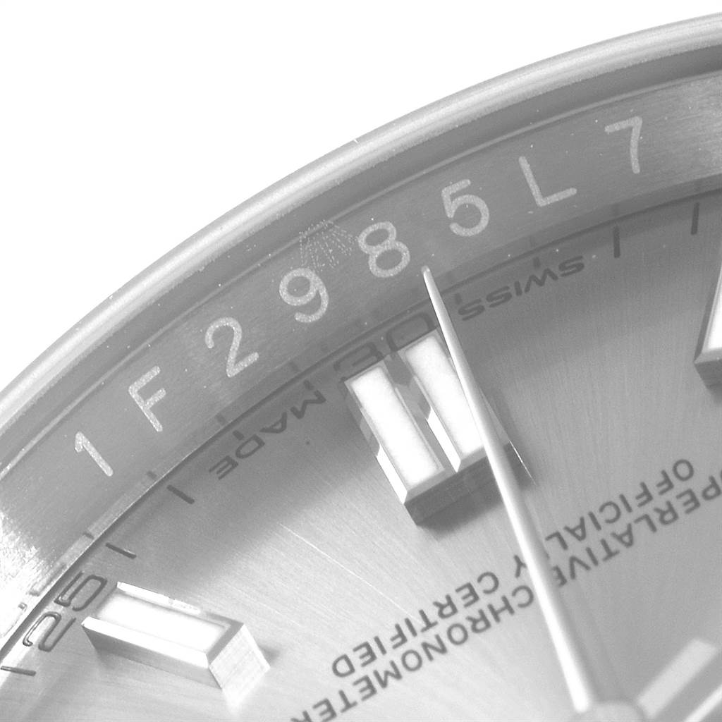 This close-up image shows the dial, hour markers, and a portion of the hands of a Rolex Oyster Perpetual 116000 Men's Stainless Steel Grey Dial 116000 Men's Stainless Steel Grey Dial watch.