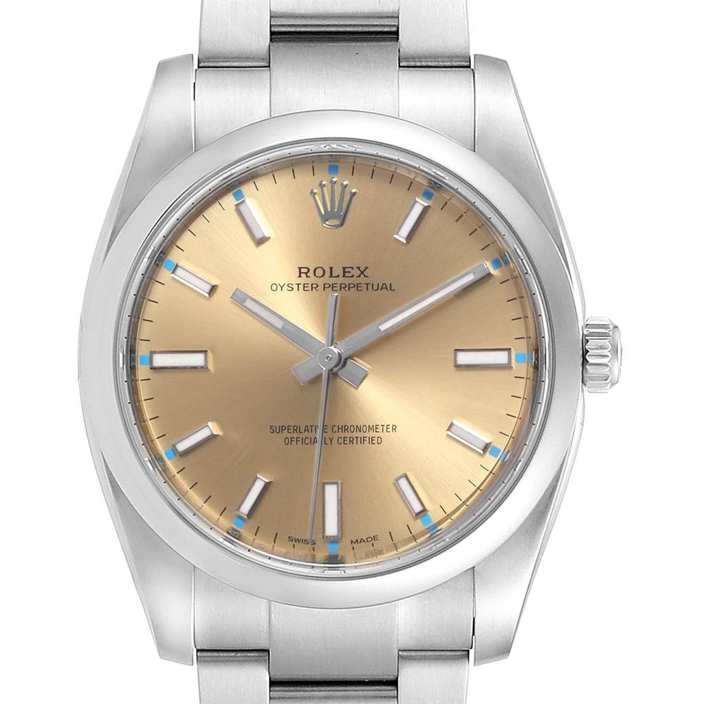 This image shows a front view of a Rolex Oyster Perpetual 114200 Men's Stainless Steel Champagne Dial 114200 Men's Stainless Steel Champagne Dial watch, displaying the dial, bezel, crown, and part of the bracelet.