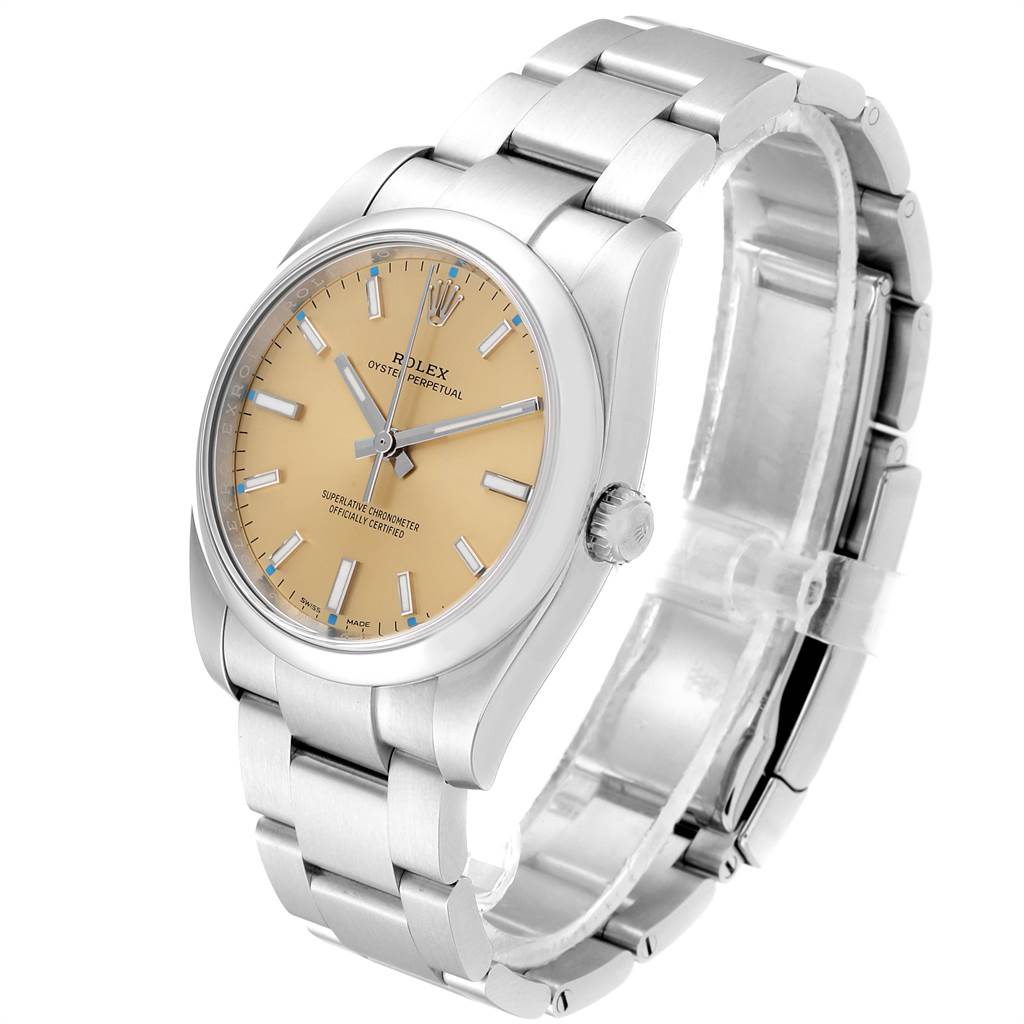The Rolex Oyster Perpetual 114200 Men's Stainless Steel Champagne Dial 114200 Men's Stainless Steel Champagne Dial watch is shown at a slight angle, featuring the bezel, face, crown, and bracelet.