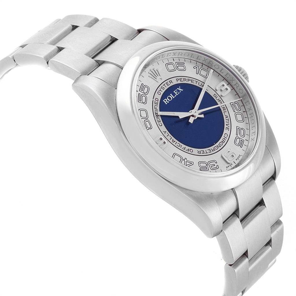 The Rolex Oyster Perpetual 116000 Men's Stainless Steel Silver Dial 116000 Men's Stainless Steel Silver Dial watch is shown at a slight angle, highlighting the bracelet, case, and dial with a blue center.