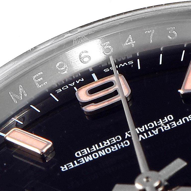 This close-up shows the dial and bezel of a Rolex Oyster Perpetual 116034 Men's Stainless Steel Black Dial 116034 Men's Stainless Steel Black Dial watch with its "9" marker and part of the second hand.