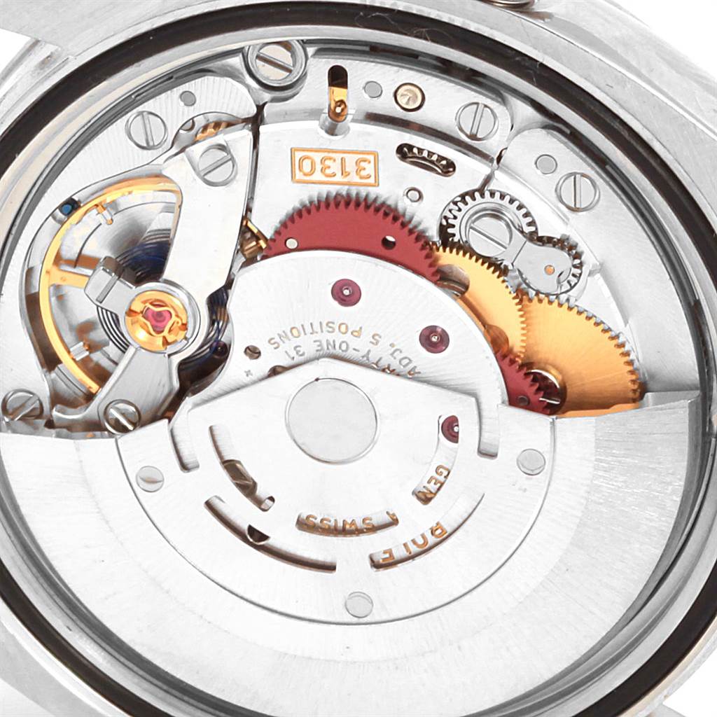 This is a close-up of the internal movement of a Rolex Oyster Perpetual 116034 Men's Stainless Steel Black Dial 116034 Men's Stainless Steel Black Dial watch, showing gears and mechanical components.