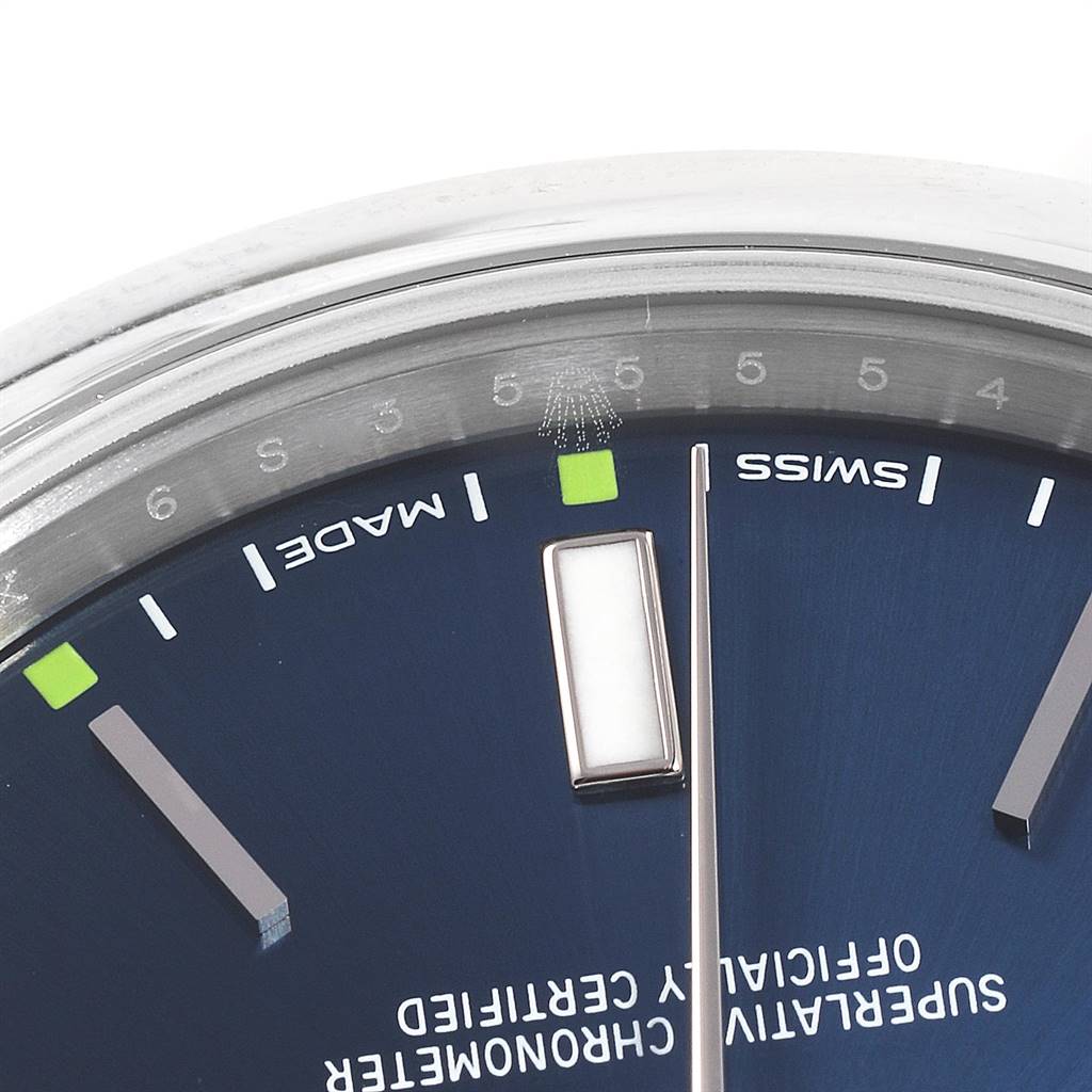 The image shows a close-up of the Oyster Perpetual Rolex watch face, highlighting the "Swiss Made" markers and part of the minute hand.
