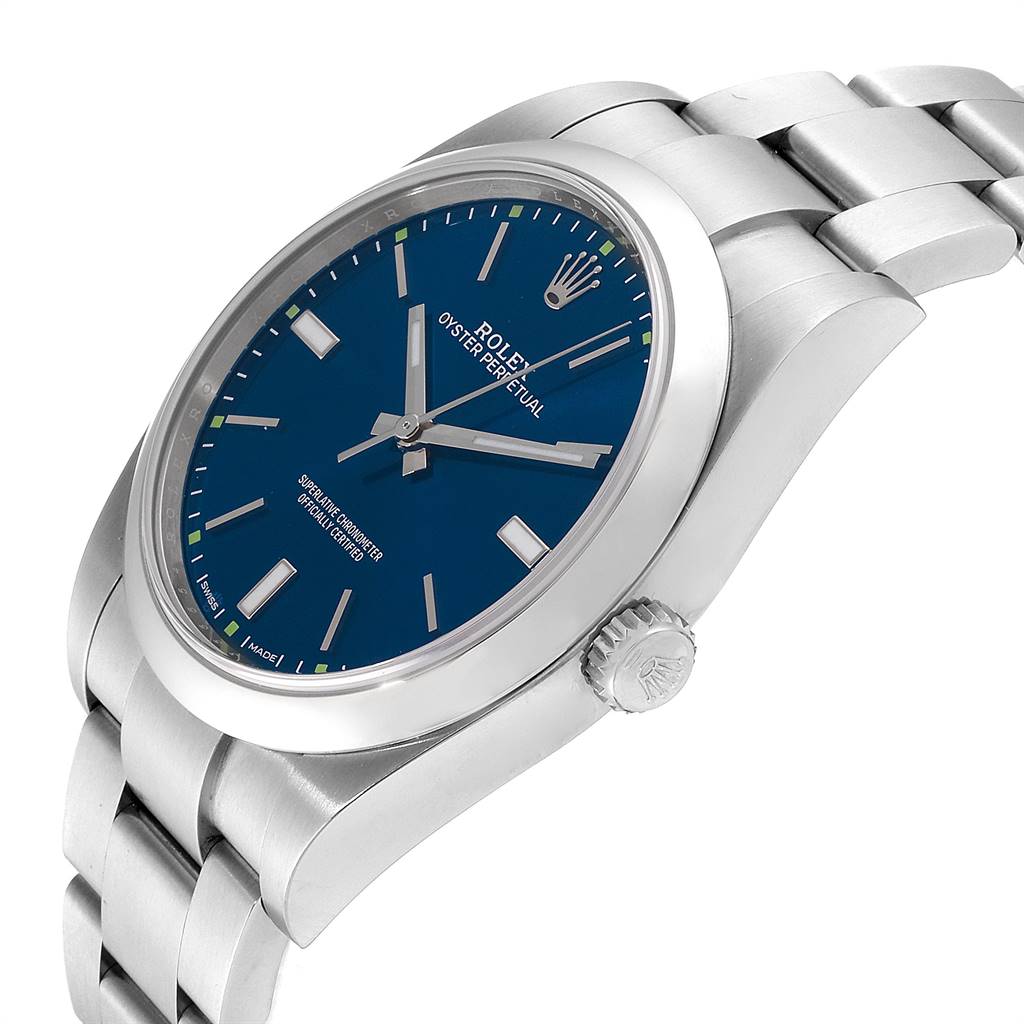 The image shows a side angle of the Rolex Oyster Perpetual 114300 Men's Stainless Steel Blue Dial 114300 Men's Stainless Steel Blue Dial watch, highlighting its dial, crown, and part of the bracelet.
