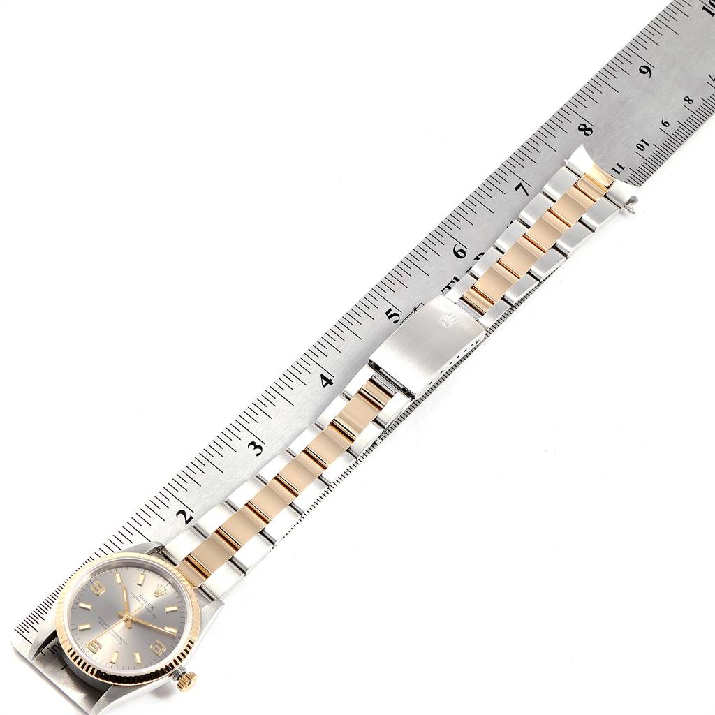 The image shows a Rolex Oyster Perpetual 14233 Men's Steel and Gold (two tone) Grey Dial 14233 Men's Steel and Gold (two tone) Grey Dial watch laid flat alongside a ruler, displaying the face and complete bracelet.